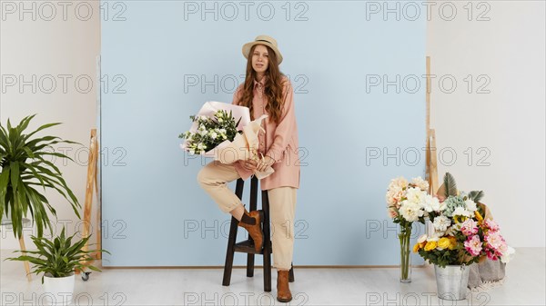 Woman posing while holding bouquet spring flowers