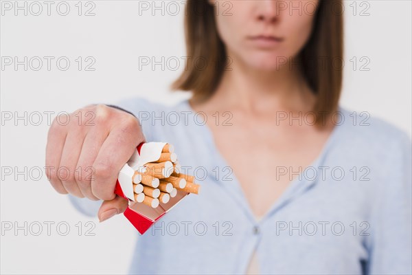 Woman s hand holding packet cigarettes