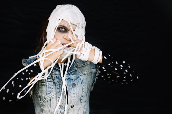 Woman taking off bandages