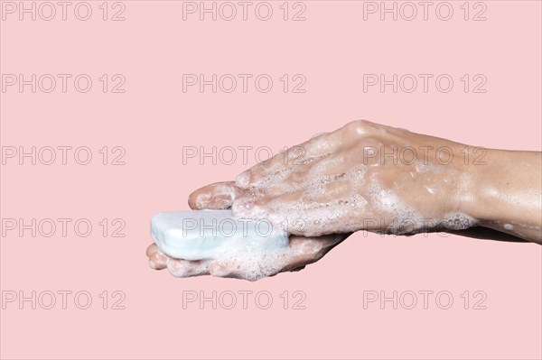 Woman washing hands with blue soap