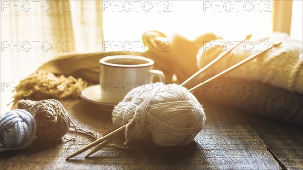 Yarn needles near hot beverage
