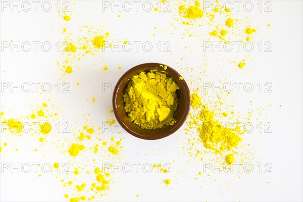 Yellow holi color powder bowl white background