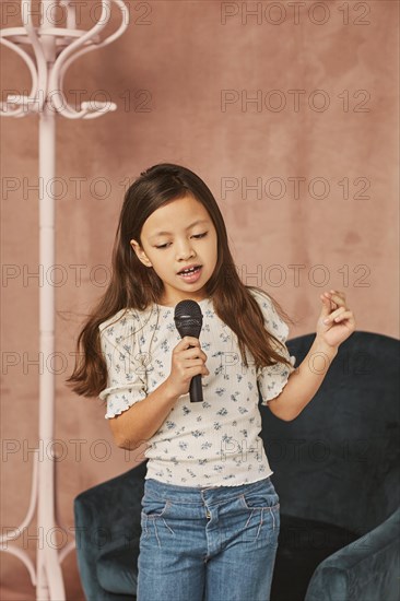 Young girl learning how sing home