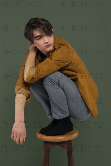 Young man wearing shirt posing chair 2