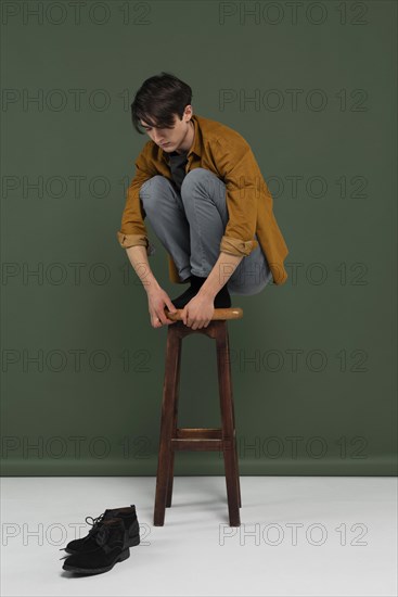 Young man wearing shirt posing chair 3