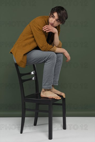 Young man wearing shirt posing chair 4