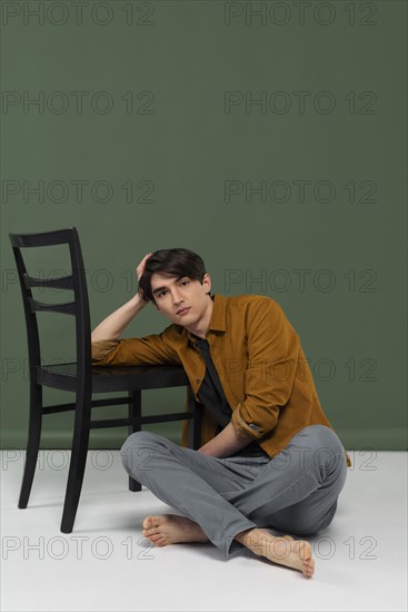Young man wearing shirt posing chair 5