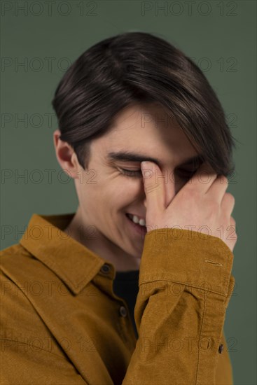 Young man wearing shirt posing while smiling