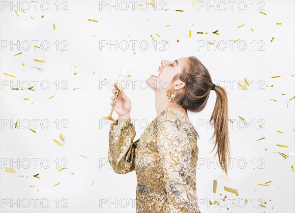 Young woman having fun party with glass champagne