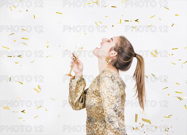 Young woman having fun party with glass champagne