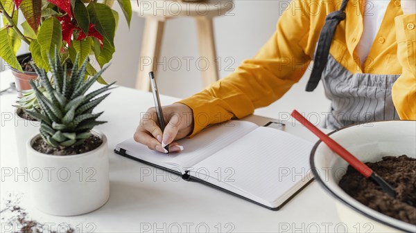 Young woman taking gardening notes