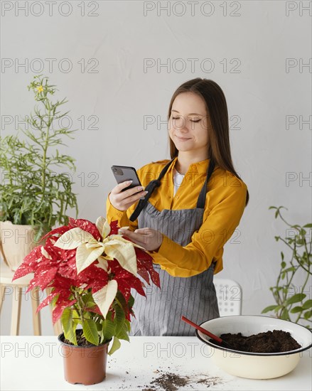 Young woman taking her plant