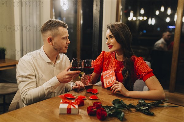 Adorable loving couple with wine cafe