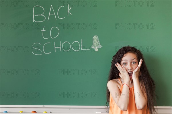 Amazed girl blackboard