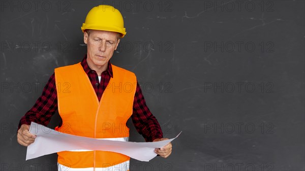 Architect checking plans with copy space