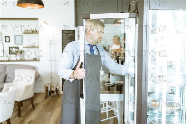 Barman opening fridge