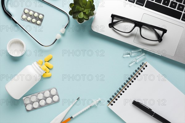 Blank white paper with clipboard pen near stethoscope blue background