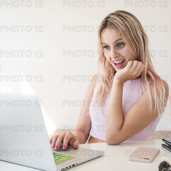 Blonde influencer using laptop