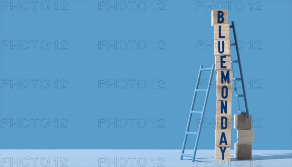 Blue monday with wooden cubes ladders copy space