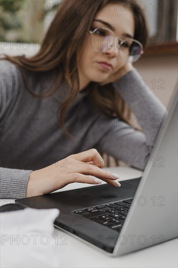 Bored young woman working from home