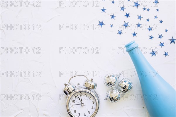 Bottle with clock spangles white table