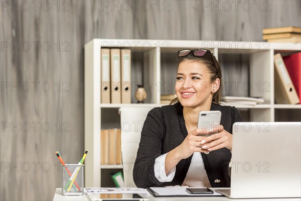 Brunette businesswoman using her smartphone 2