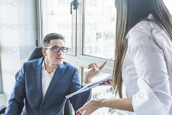 Businessman asking questions businesswoman office