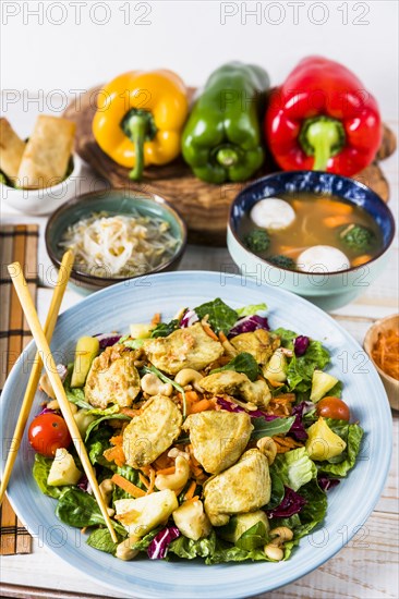 Chicken salad with chopsticks beans sprout fish ball soup table