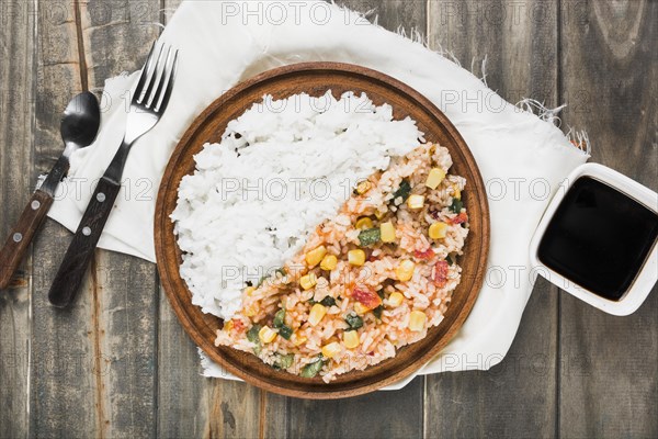 Chinese fried steamed rice wooden plate with soya sauce table