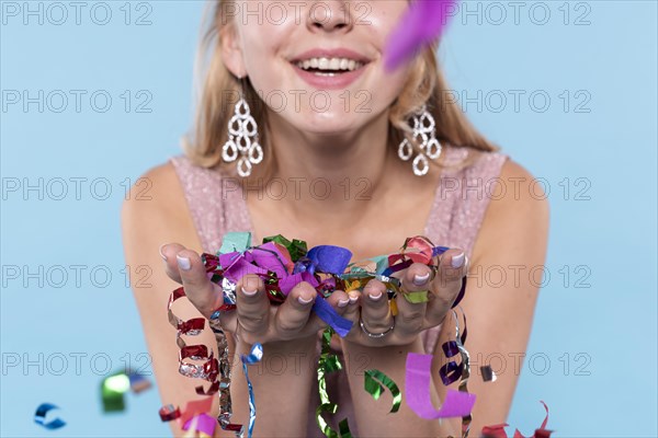 Close up beautiful woman holding confetti