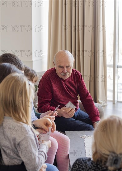 Close up family members playing cards