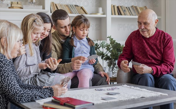 Close up family members playing games