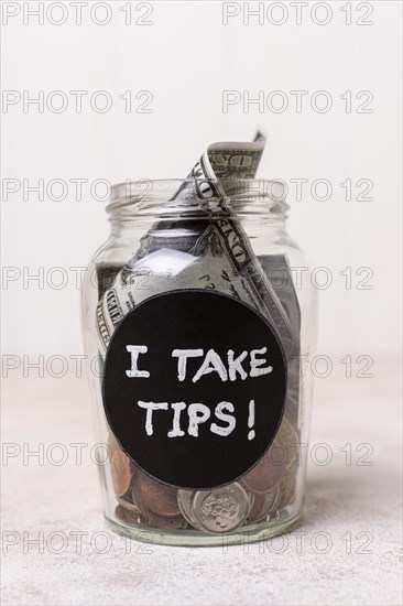 Close up glass with money as tips