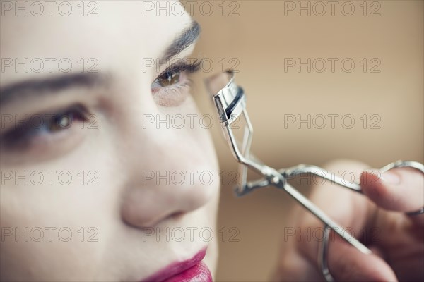 Close up hand curling eyelashes model