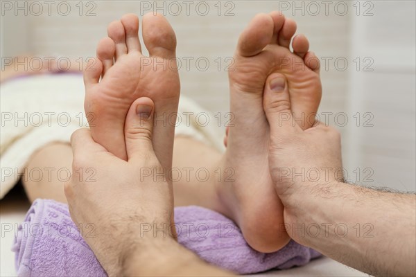 Close up hands massaging soles