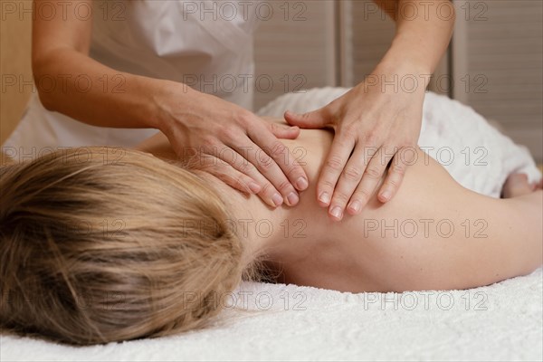 Close up hands massaging woman s back