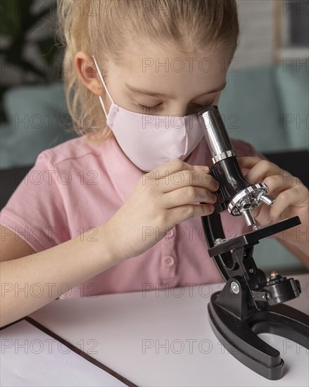 Close up kid learning with microscope