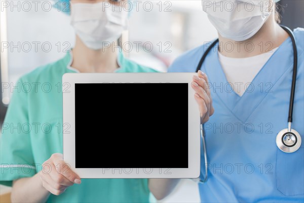 Close up nurses holding chalkboard