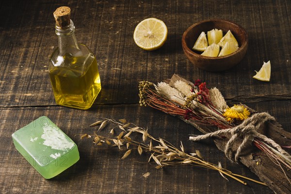 Close up shot olive oil with lemon plants soap bar