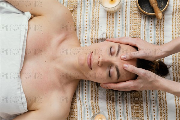 Close up therapist massaging forehead