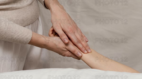 Close up therapist massaging hand