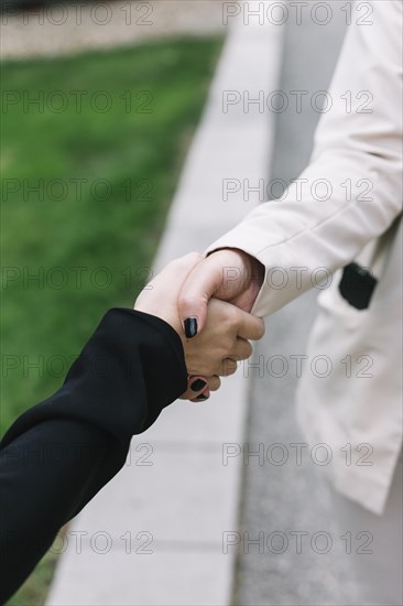 Close up two businesswomen shaking hands