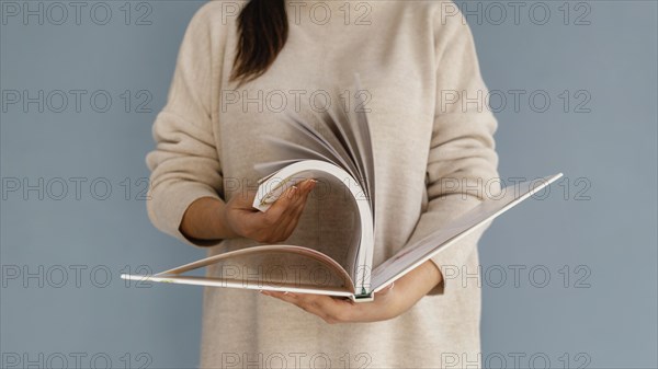 Close up woman browsing through book