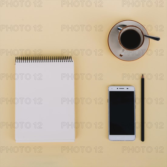 Coffee smartphone near notebook