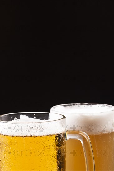 Cold beer mugs with foam