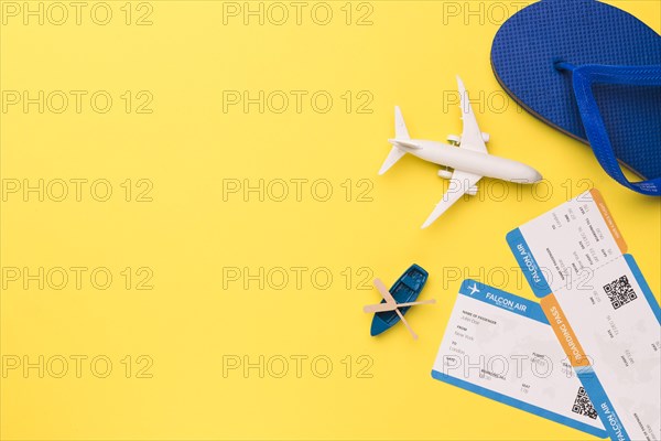 Composition toy airplane boat tickets flip flops