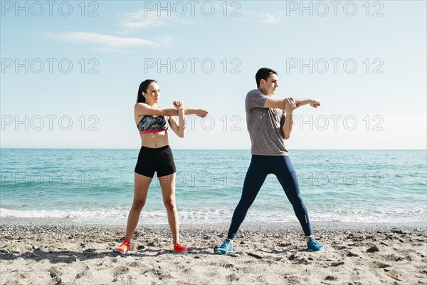 Couple stretching beach