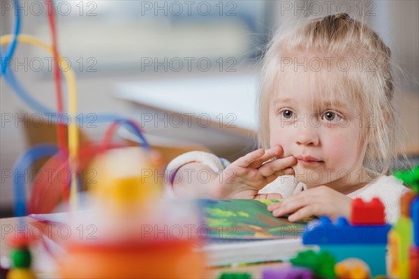 Cute preschooler girl looking away