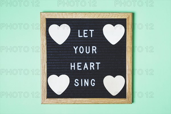 Decorated board with message heart shape turquoise backdrop