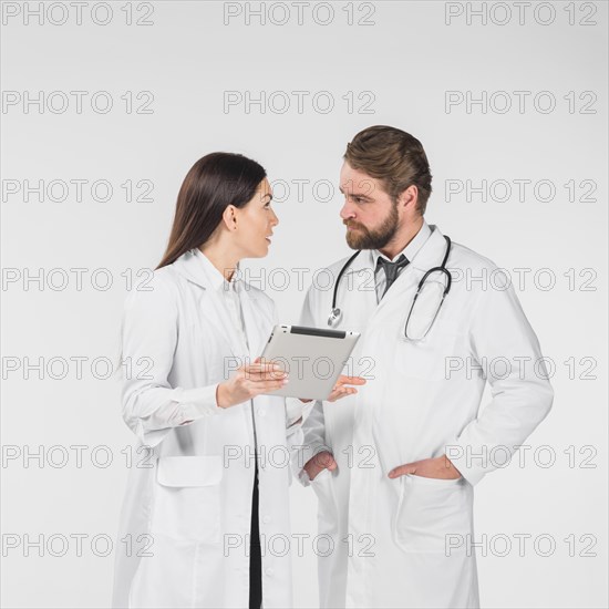 Doctors female male discussing looking each other